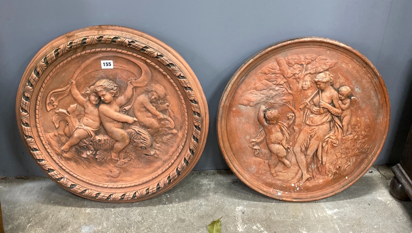 Two circular terracotta plaques embossed with cherubs and classical figures, larger diameter 54cm